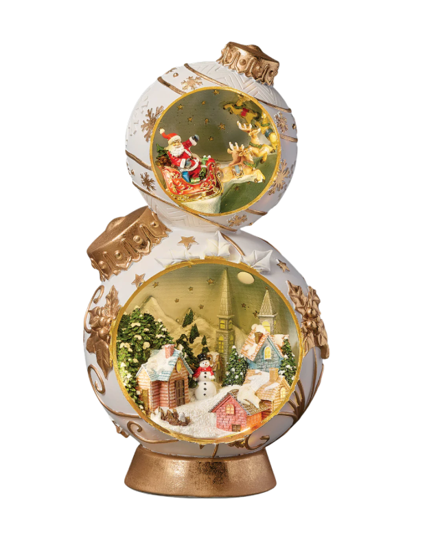 Christmas Ornament Tower with Santa Flying Over Town